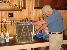 John Gaspie works on cleaning a lens at the Maine Lighthouse Museum