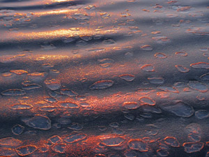 Sunset splashes its final colors on ice laden waters