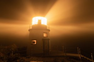 Owls Head Lighthouse shining into the fog