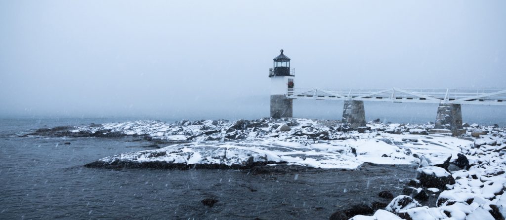 Snow swirls around the Marshall Point Lighthouse
