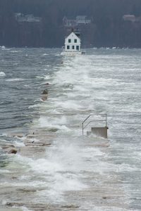 Storm waves crashing over the Rockland Breakwater Lighthouse