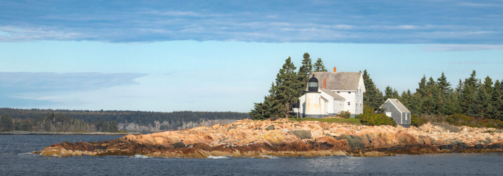 Winter Harbor Lighthouse under a dark cloud