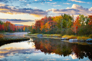 Beautiful fall colors reflect in a glassy creek.